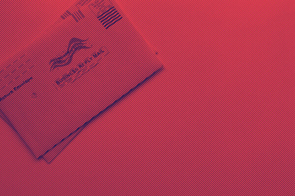 Vote by mail ballot on red and blue background