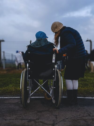 Person in wheelchair with caregiver