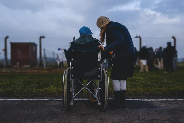 Person in wheelchair with caregiver