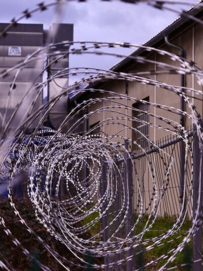 A photo of barbed wire outside a prison.