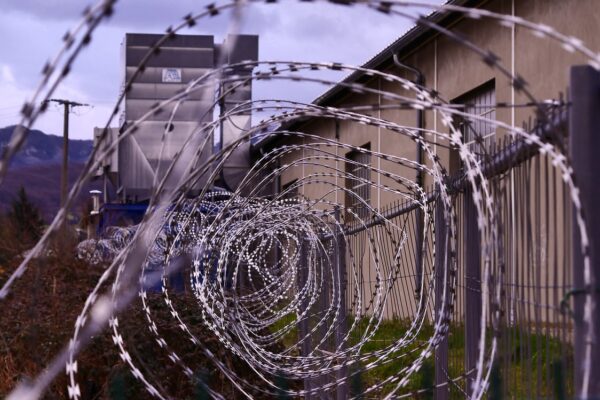 A photo of barbed wire outside a prison.