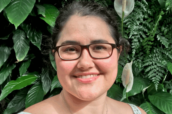 Headshot of Rachael against a plant wall.