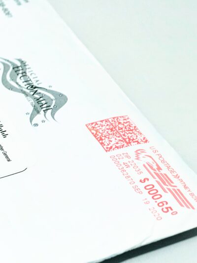 Close-up photo of a mail-in ballot, placed diagonally on a white background.