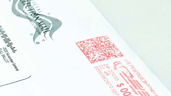 Close-up photo of a mail-in ballot, placed diagonally on a white background.