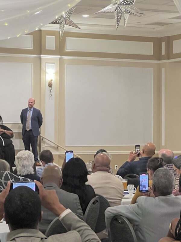 Core Priest accepts his Kandler Award in a room full of guests at Hockessin Memorial Hall during the 2022 Kandler Awards Celebration.