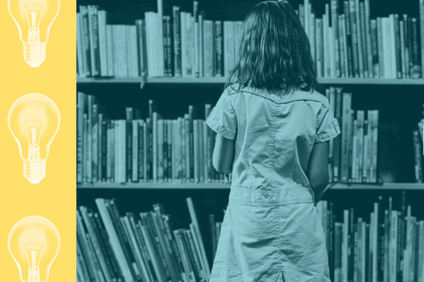 Young student standing in front of a bookcase