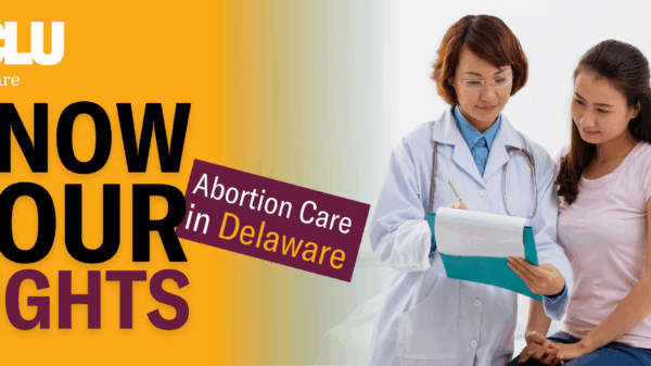 A doctor with a patient both looking at a clipboard