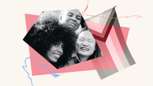 Close up of three people with big smiles to the left of the progress Pride flag