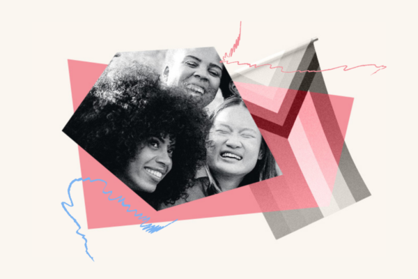 Close up of three people with big smiles to the left of the progress Pride flag