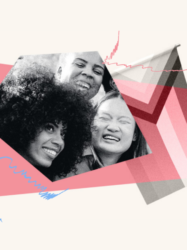 Close up of three people with big smiles to the left of the progress Pride flag