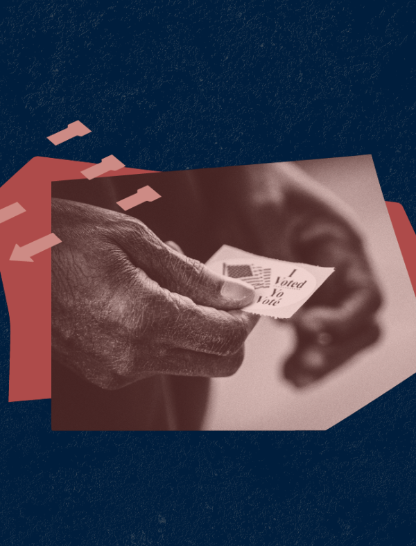 Image of hands holding an "I voted" sticker against a blue background