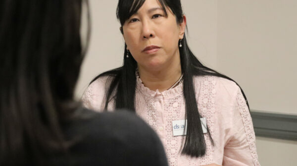 candid photo of Gloria Ho speaking with someone at HB94 lobby day