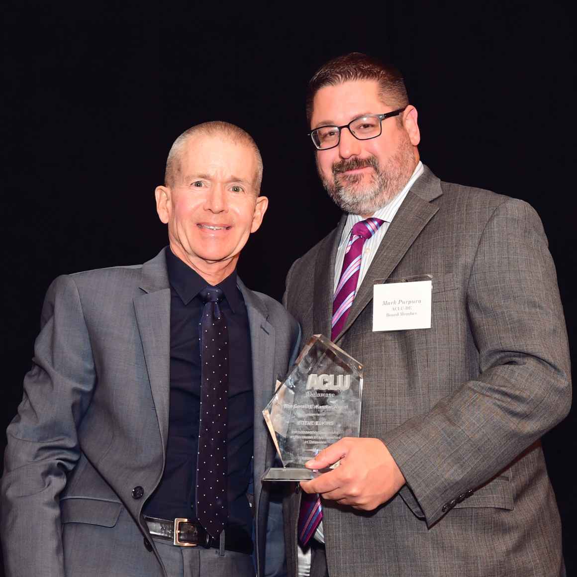 Mark Purpura and Murray Archibald accept award on behalf of Steve Elkins