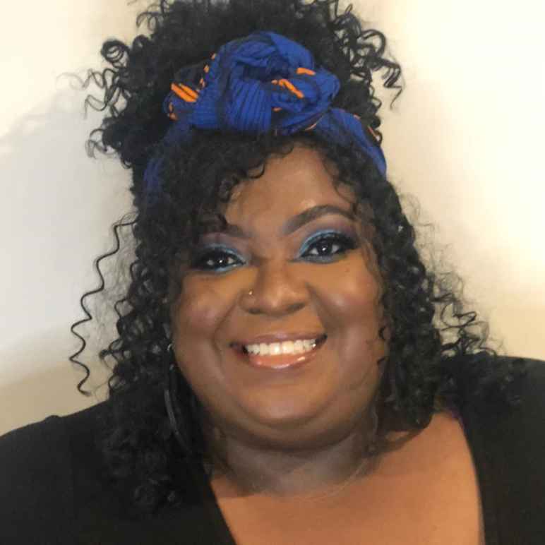 A headshot of Nyemade Boiwu wearing her curly hair half-up, half-down, a black shirt, and a royal blue scarf in her hair with orange details.