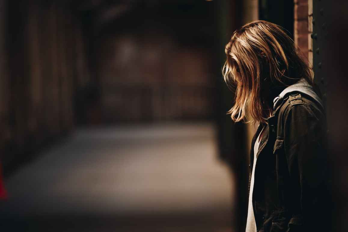 Person standing against wall