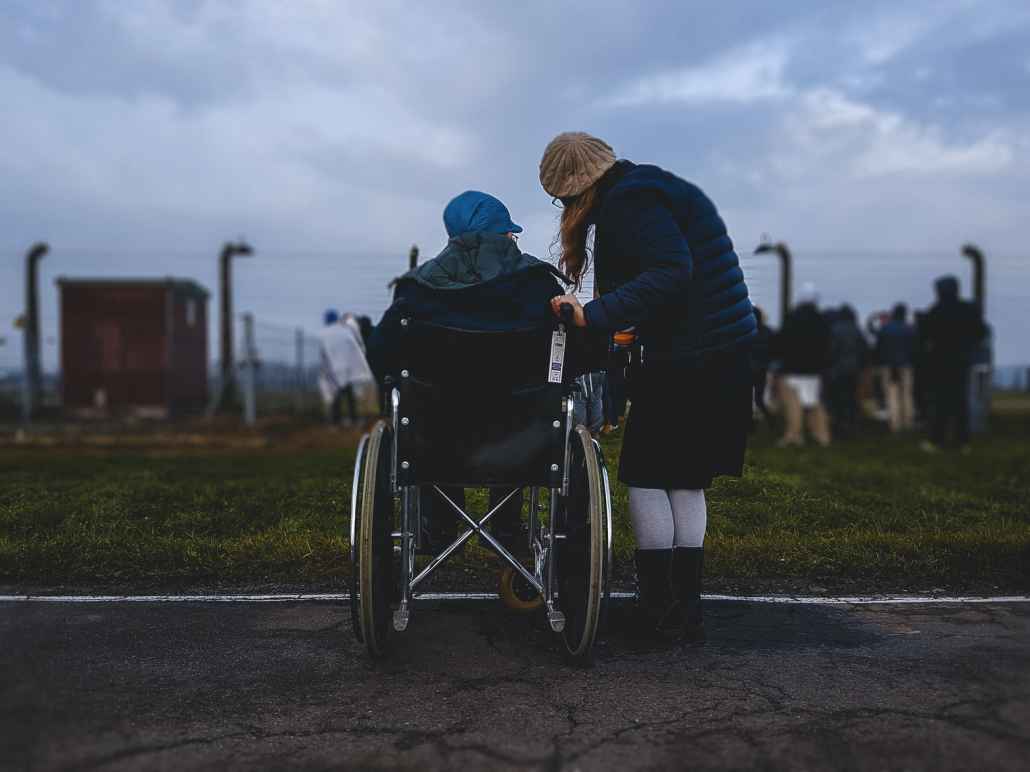 Person in wheelchair with caregiver