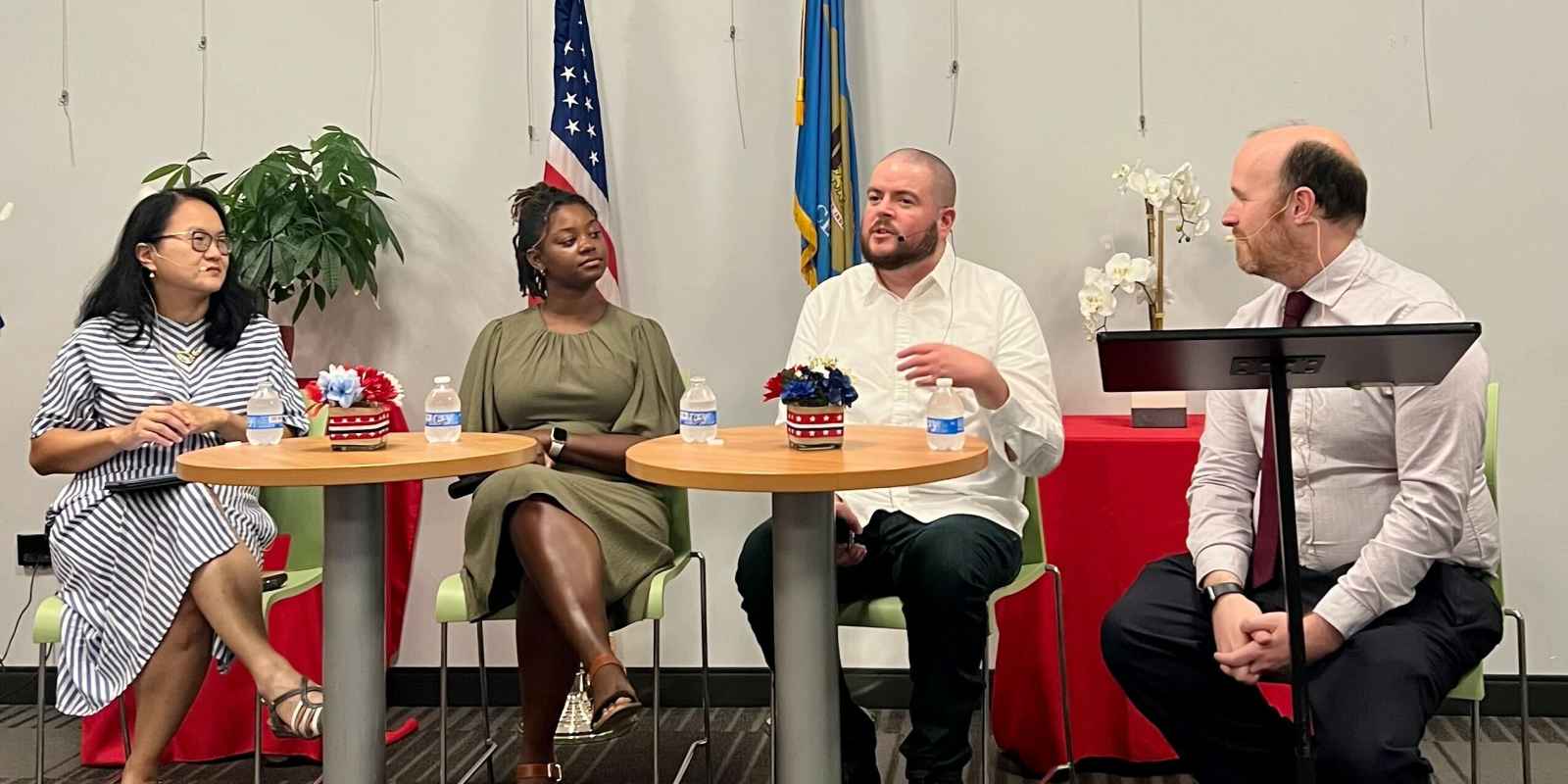 Four people seated side-by-side for a panel discussion