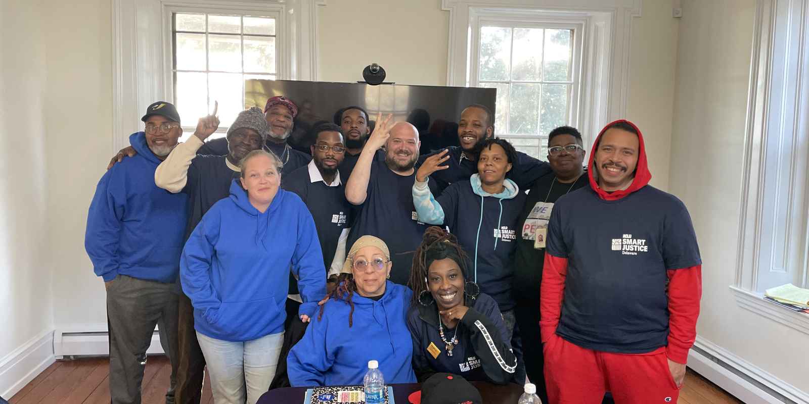 Group of people in blue and navy shirts indoors