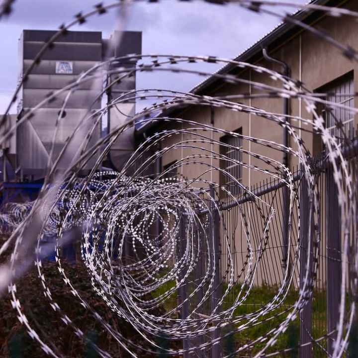 A photo of barbed wire outside a prison.