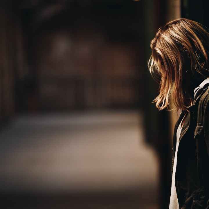 Person standing against wall