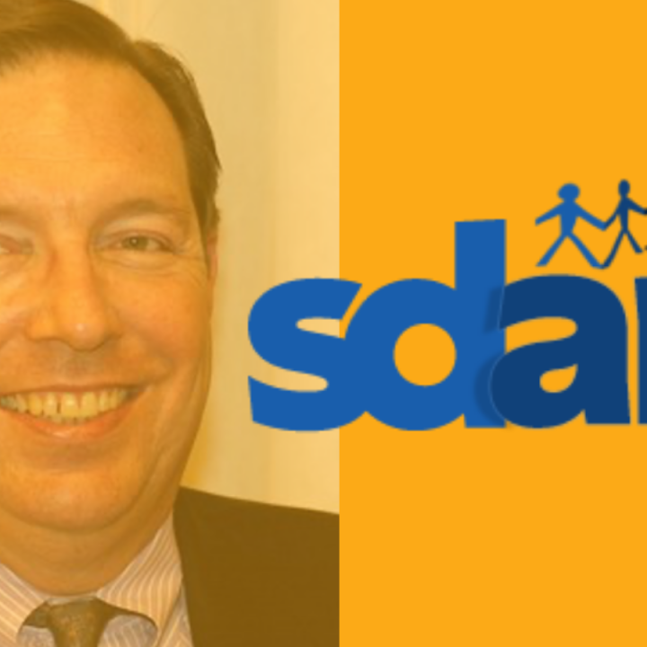 Headshot of Tom Irvine with Southern Delaware Alliance for Racial Justice logo