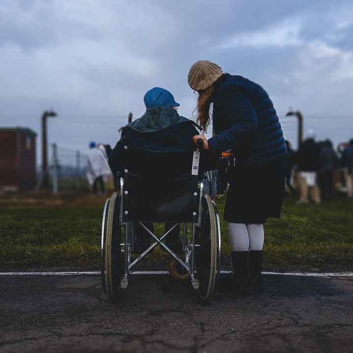 Person in wheelchair with caregiver