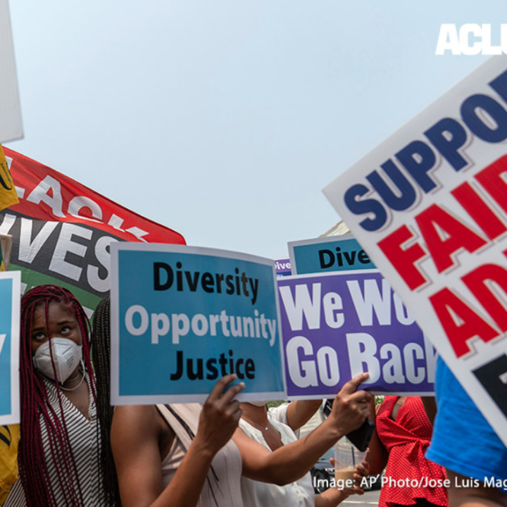 A crowd of protestors holding signs that with "DEI" related slogans like "Diversity, Opportunity, Justice"